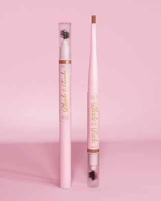 An image of two P.Louise Blade & Fade Eyebrow Pencils With Brush, one with the lid on and the other with the lid off showing the blade against a pink background