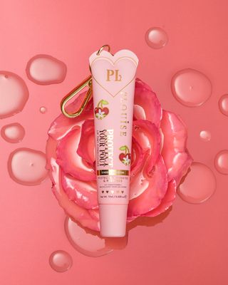 Pink cherry blossom-scented tinted protect your pout lip conditioner with gold clip on top of a pink flower