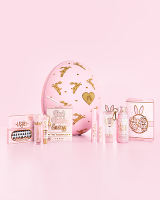 Pink P.Louise Easter Egg surrounded by pink marshmallow scented makeup, skincare and bodycare products against a pink background