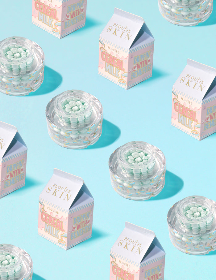 Clear containers of P.Louise Dose of Dreams Vitamin C Capsule Cream with blue capsule within them surrounded by  milk cartons