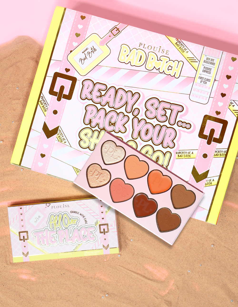 P.Louise All Over The Place 面部调色板包装和产品在沙床上以各种颜色的心形平底锅色调展示。