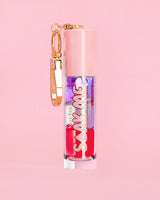 P. Louise Soak Me Lip Oil，粉红色管中含有彩色分层油，粉红色背景上有金色扣