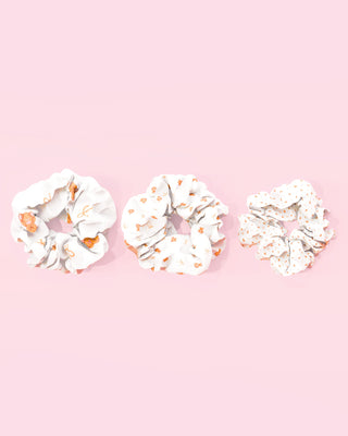 Three womens white hair scrunchies with various teddy bear prints